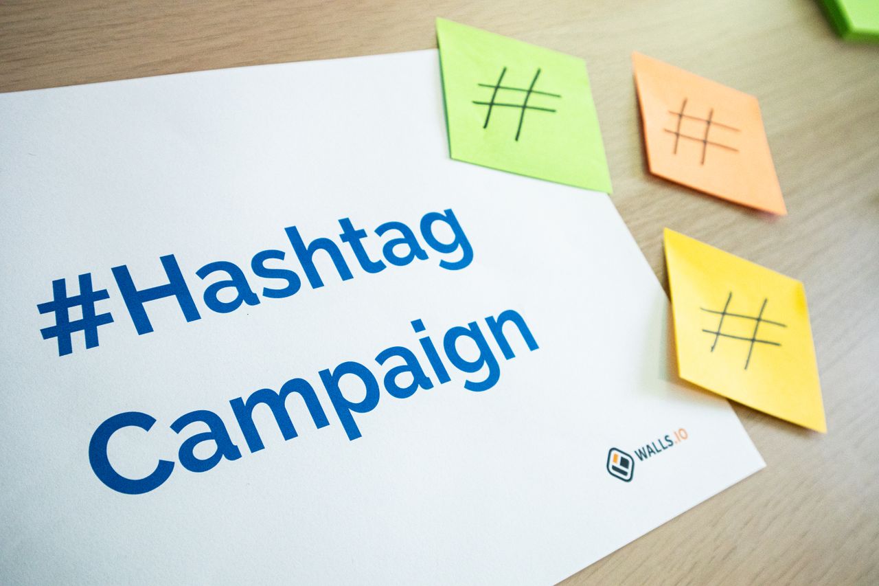 An organized workspace with hashtag campaign materials and colorful sticky notes.